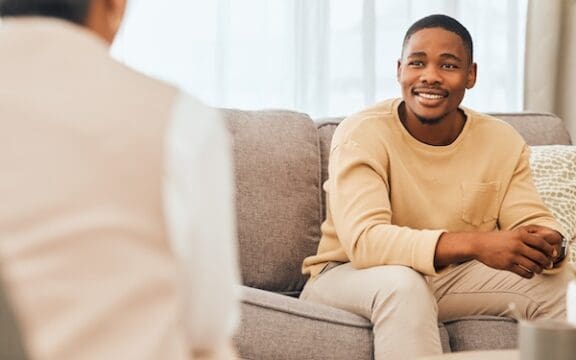 A patient and a psychiatrist who may be discussing an accelerated TMS protocol
