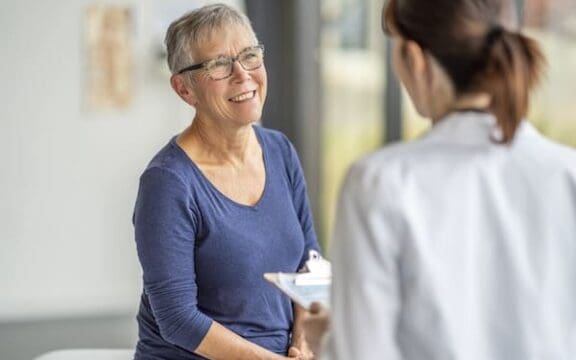 Pharmacogenetic testing for depression represented by a medical provider explaining something to a patient.