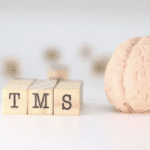 picture of a brain next to tms blocks detailing how many sessions for tms to work effectively