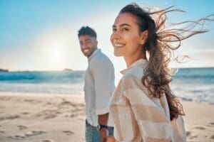 Shot of a young couple spending time together at the beach, demonstrating how ketamine can improve quality of life for people with Depression