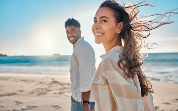 Shot of a young couple spending time together at the beach, demonstrating how ketamine can improve quality of life for people with Depression