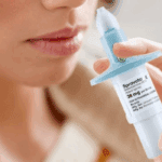 A person raising nasal spray to demonstrate the efficacy of Spravato for NYC patients