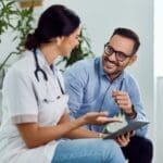 A doctor and patient engage in a friendly conversation about esketamine as a glutamate depression treatment